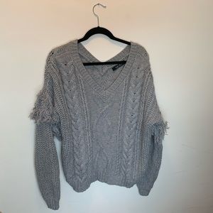 Gray knit sweater with fringe